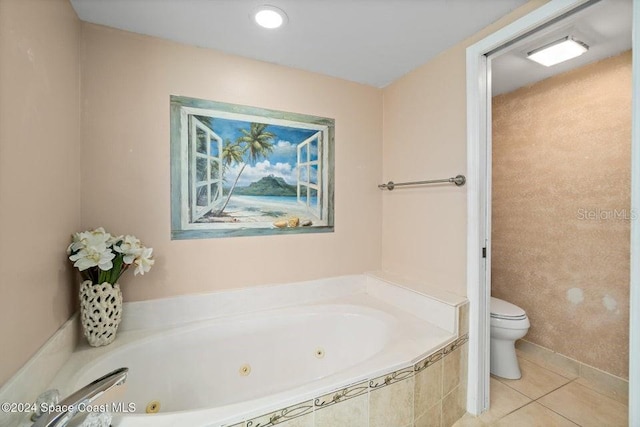 bathroom featuring tile patterned flooring, a relaxing tiled tub, and toilet