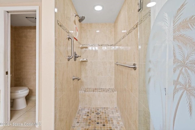 bathroom featuring toilet and tiled shower