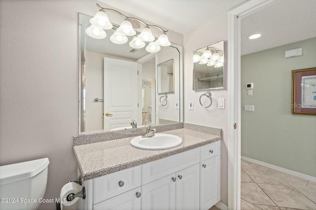 bathroom with tile patterned floors, vanity, and toilet