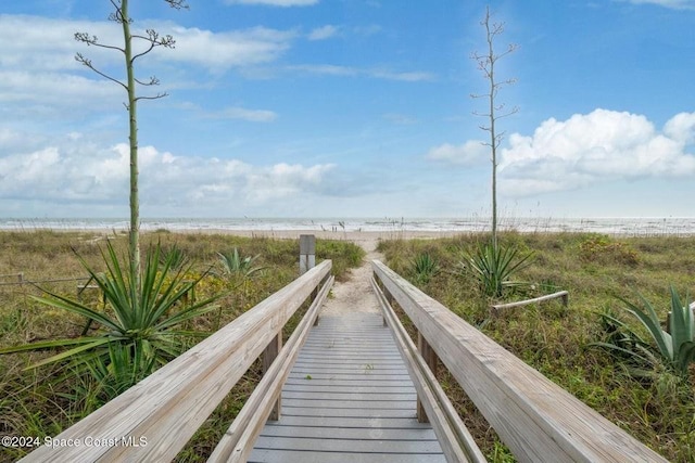 view of property's community featuring a view of the beach and a water view