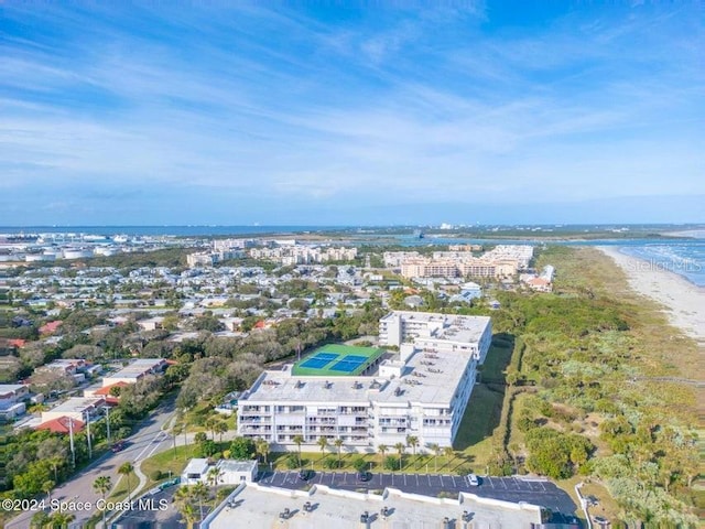 bird's eye view with a water view and a beach view