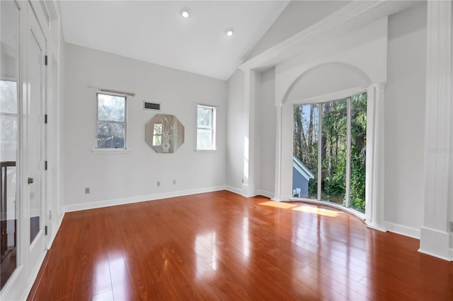 unfurnished room with hardwood / wood-style floors and lofted ceiling