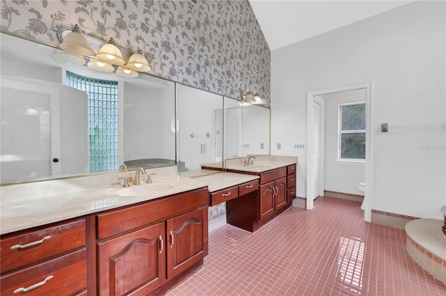 bathroom featuring tile patterned flooring, vanity, toilet, and lofted ceiling