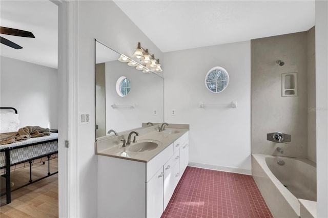 bathroom featuring vanity, a tub to relax in, and ceiling fan