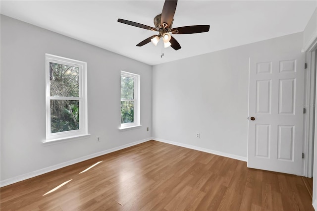 unfurnished room with ceiling fan and wood-type flooring