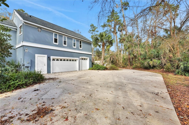 view of side of property featuring a garage