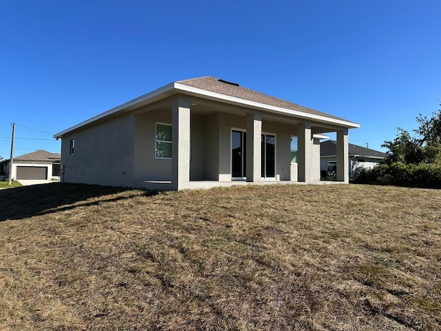 rear view of house with a lawn