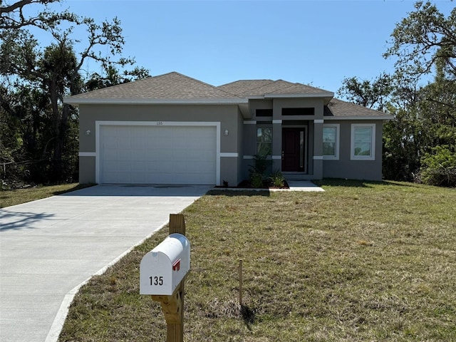 prairie-style house featuring a garage and a front yard