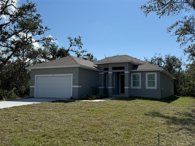 view of front of home with a garage and a front lawn