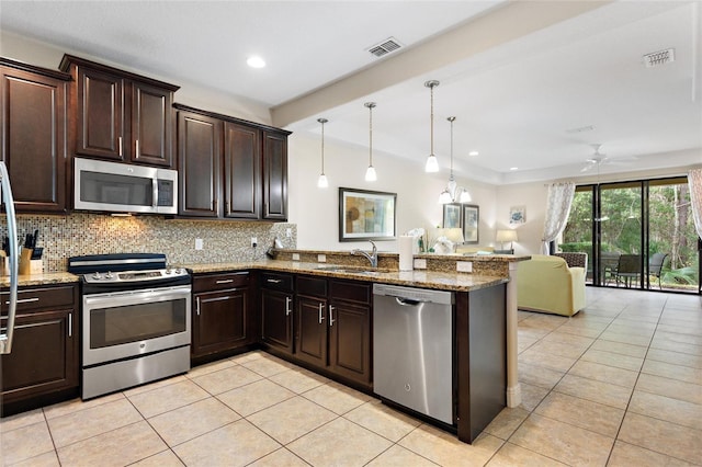 kitchen featuring kitchen peninsula, ceiling fan, sink, and appliances with stainless steel finishes