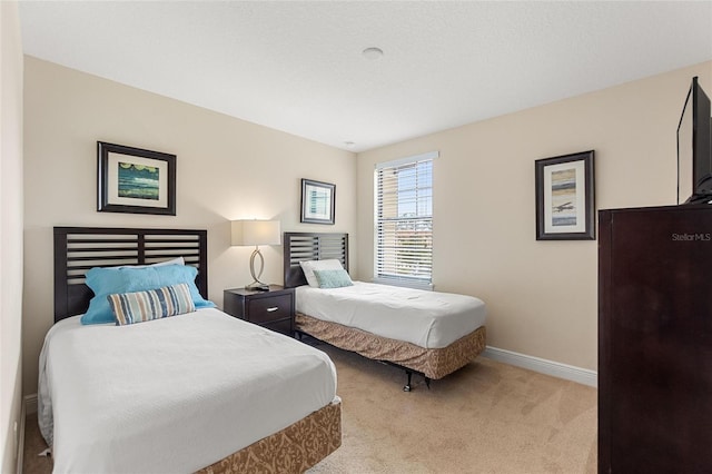 bedroom with light colored carpet