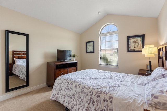 carpeted bedroom with lofted ceiling