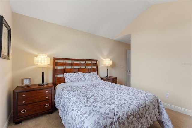 bedroom with lofted ceiling and light carpet