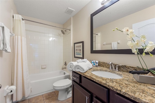 full bathroom with tile patterned floors, shower / bath combination with curtain, a textured ceiling, toilet, and vanity