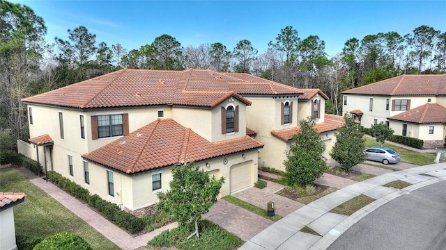 mediterranean / spanish-style home with a garage