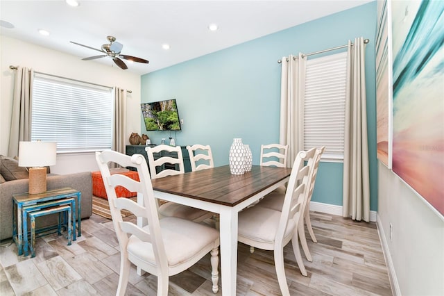 dining area with light hardwood / wood-style flooring and ceiling fan