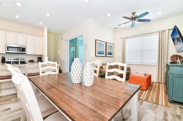 dining area with ceiling fan and light hardwood / wood-style flooring