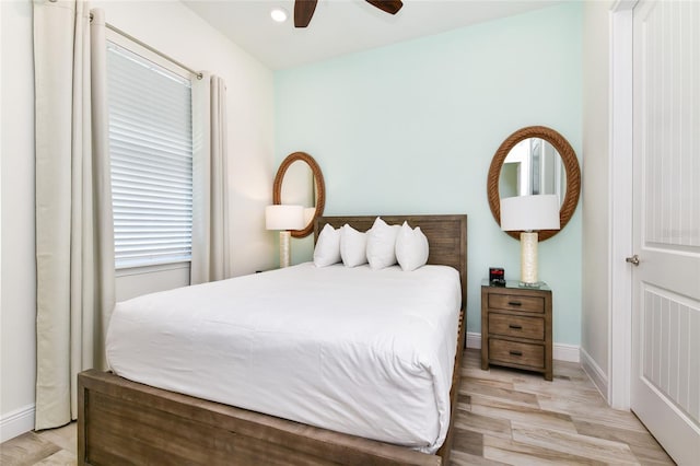 bedroom with ceiling fan and light hardwood / wood-style flooring