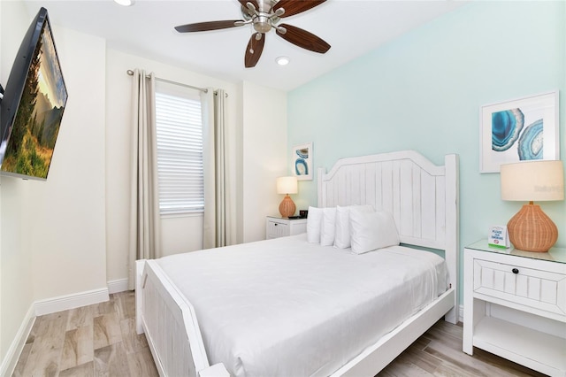 bedroom with light wood-type flooring and ceiling fan