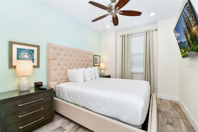 bedroom with light wood-type flooring and ceiling fan