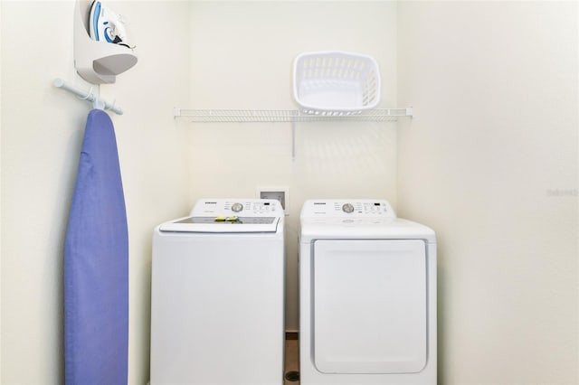 laundry area with washing machine and dryer