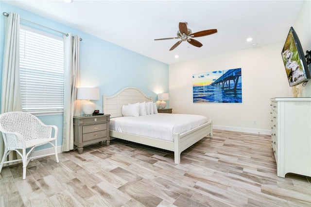 bedroom with light wood-type flooring and ceiling fan