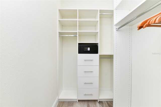 spacious closet featuring light hardwood / wood-style flooring