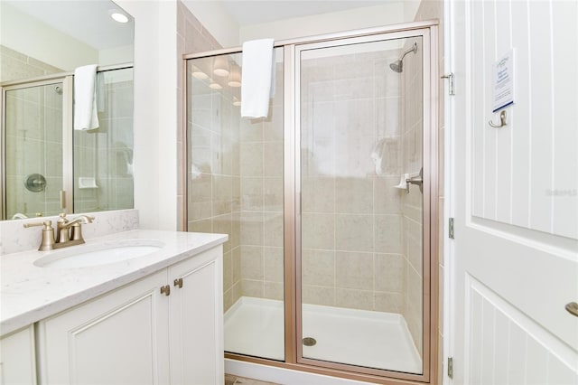 bathroom featuring vanity and an enclosed shower