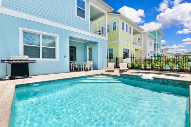 view of swimming pool featuring a patio area and grilling area