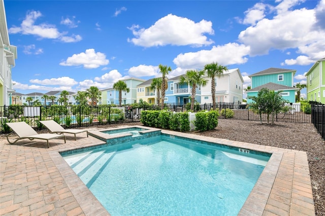 view of swimming pool with a patio area and an in ground hot tub