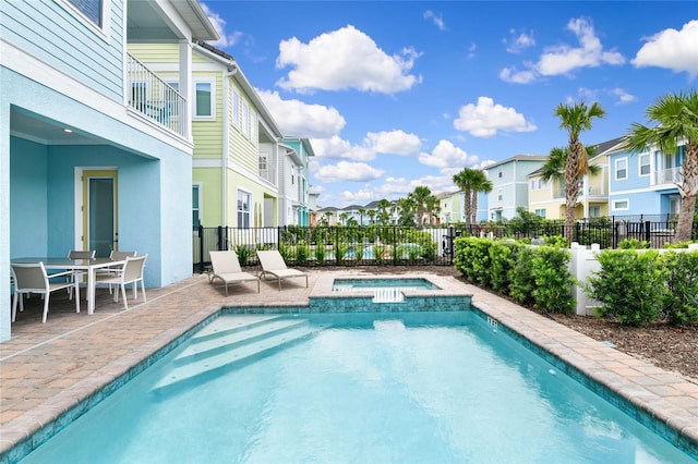 view of pool with an in ground hot tub and a patio