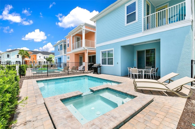 view of pool featuring an in ground hot tub and a patio area