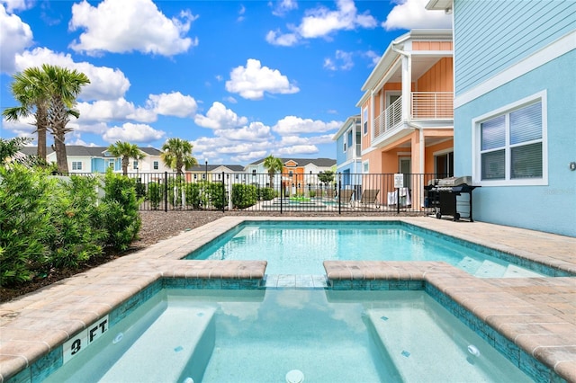 view of pool featuring an in ground hot tub and grilling area