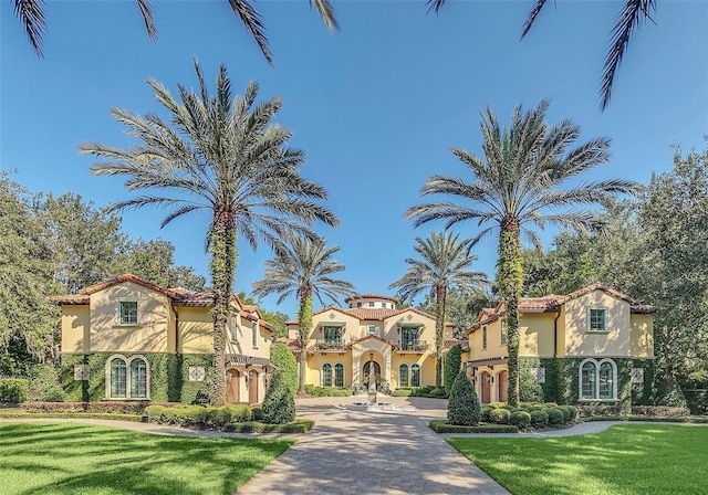 mediterranean / spanish-style home with a front yard