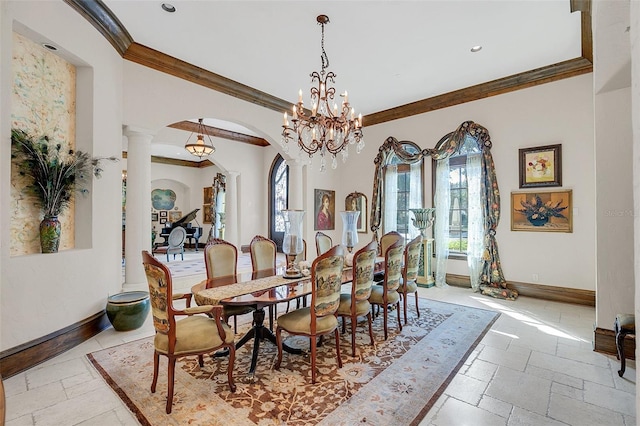 dining space featuring a notable chandelier, ornate columns, and crown molding