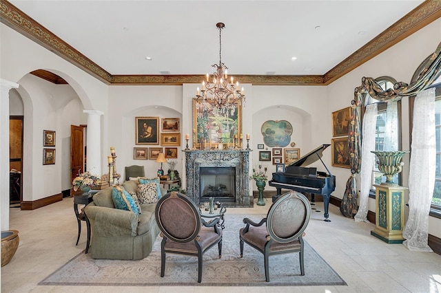 living room featuring an inviting chandelier, ornate columns, a healthy amount of sunlight, and a premium fireplace