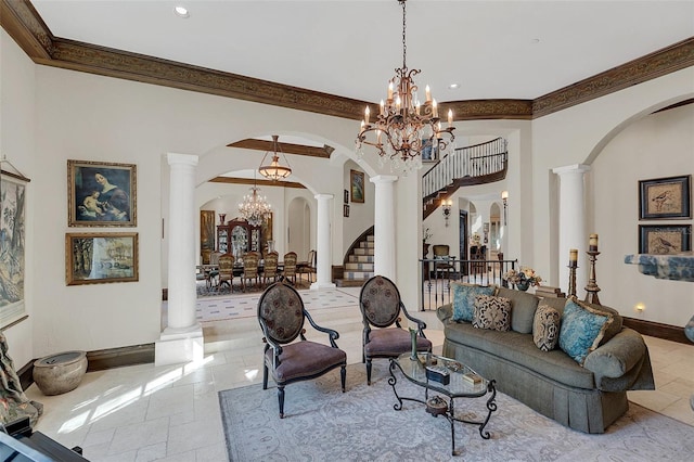 living room with a notable chandelier, ornamental molding, and decorative columns