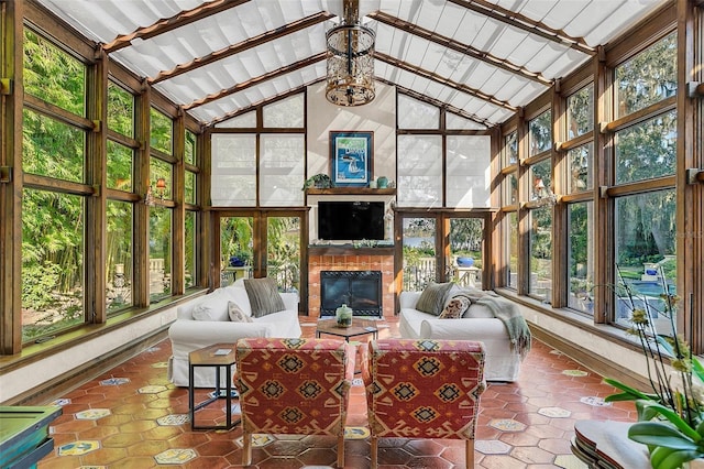 sunroom / solarium featuring vaulted ceiling with beams