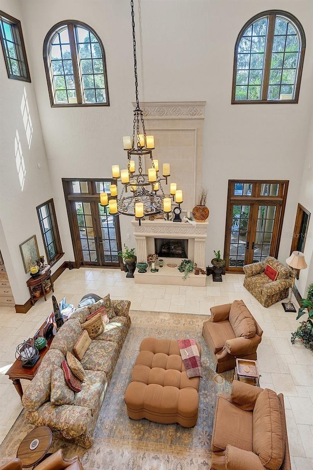 living room featuring a chandelier, a high ceiling, and french doors