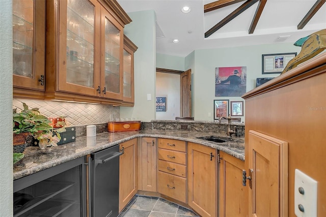 kitchen featuring dark stone countertops, sink, wine cooler, and tasteful backsplash