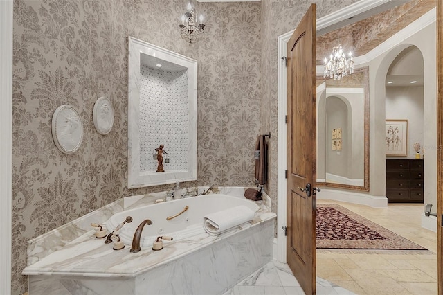 bathroom featuring tiled bath, a notable chandelier, and ornamental molding