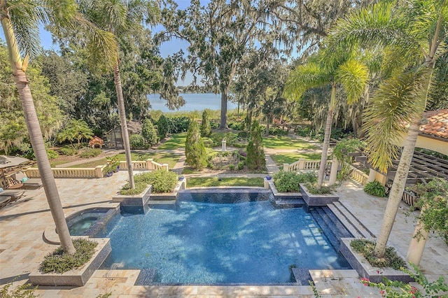 view of swimming pool featuring a patio area and an in ground hot tub