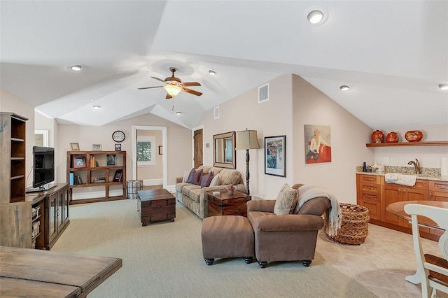 living room with ceiling fan, indoor wet bar, and vaulted ceiling