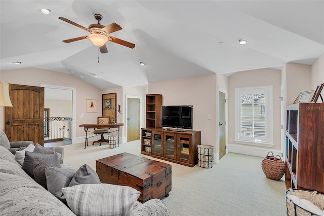 living room featuring ceiling fan, light carpet, and vaulted ceiling