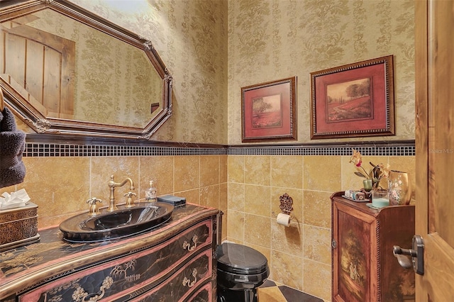 bathroom with vanity and tile walls