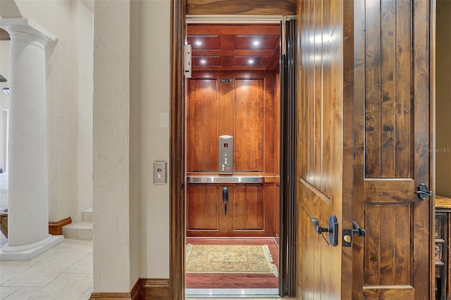 room details featuring ornate columns, wooden walls, and elevator