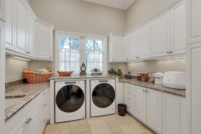 washroom with cabinets, sink, and washing machine and dryer