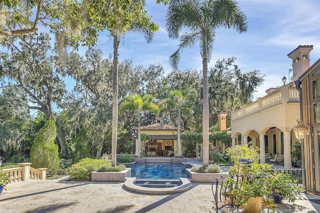 exterior space with a swimming pool with hot tub