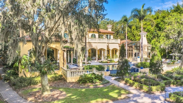 back of property with a balcony