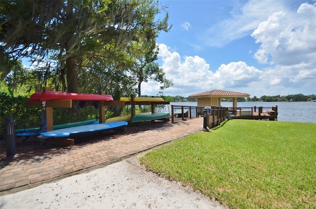 dock area featuring a gazebo, a yard, and a water view